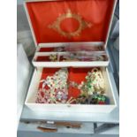 A TWO TIER JEWELLERY CASE AND CONTENTS INCLUDING; A SILVER GILT BAR BROOCH WITH ENAMELLED FLOWER