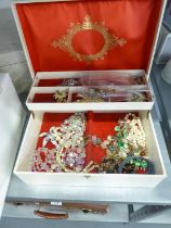 A TWO TIER JEWELLERY CASE AND CONTENTS INCLUDING; A SILVER GILT BAR BROOCH WITH ENAMELLED FLOWER