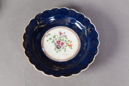 EIGHTEENTH CENTURY WORCESTER PORCELAIN SCALLOPED PLATE, the centre enamelled with a floral spray