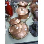 A SET OF FIVE TURKISH HEAVY, COPPERED METAL PANS WITH BRASS HANDLES AND TWO SIMILAR SHALLOW PANS (7)