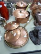 A SET OF FIVE TURKISH HEAVY, COPPERED METAL PANS WITH BRASS HANDLES AND TWO SIMILAR SHALLOW PANS (7)