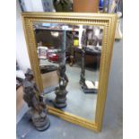 A RECTANGULAR GILT FRAMED BEVELLED EDGE WALL MIRROR (84cm x 60cm)