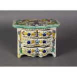 CONTINENTAL MAIOLICA POTTERY MINIATURE CHEST OF DRAWERS, with shaped front and two short and wo long
