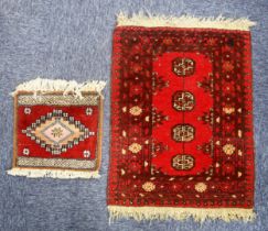 TURKOMAN BOKHARA SMALL RUG OR MAT with a single row of four guls on a crimson field, multi-stripes