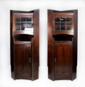 LIBERTY, LONDON, PAIR OF DARK OAK FLOOR STANDING CORNER CABINETS, each with shelf top above a nine