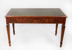 EARLY TWENTIETH CENTURY FIGURED WALNUT WRITING TABLE, the moulded oblong top with gilt tooled