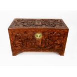 CHINESE CARVED CAMPHOR WOOD BEDDING BOX, of typical form with hinged lid and engraved brass lock
