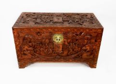 CHINESE CARVED CAMPHOR WOOD BEDDING BOX, of typical form with hinged lid and engraved brass lock