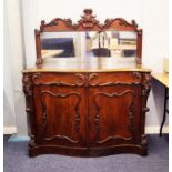 MID NINETEENTH CENTURY CARVED MAHOGANY SERPENTINE FRONTED CHIFFONIER, the oblong mirrored plate in