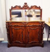MID NINETEENTH CENTURY CARVED MAHOGANY SERPENTINE FRONTED CHIFFONIER, the oblong mirrored plate in