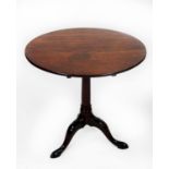 GEORGIAN MAHOGANY TILT TOP OCCASIONAL TABLE, the circular top set above a gun barrel turned