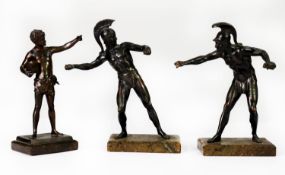 EARLY 20th CENTURY DARK PATINATED BRONZE CLASSICAL FIGURE OF A BOY standing releasing a bird from