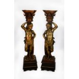 PAIR OF CONTINENTAL CARVED GILTWOOD FIGURAL TORCHERES, each modelled as semi naked cherub supporting