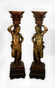 PAIR OF CONTINENTAL CARVED GILTWOOD FIGURAL TORCHERES, each modelled as semi naked cherub supporting