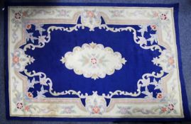 CHINESE ACRYLIC CARPET OF AUBUSSON DESIGN with white and floral centre and border, plain royal