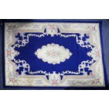 CHINESE ACRYLIC CARPET OF AUBUSSON DESIGN with white and floral centre and border, plain royal