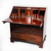 GEORGE III MAHOGANY BUREAU WITH WELL FITTED INTERIOR, the oblong top above a flame cut fall,