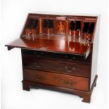 GEORGE III MAHOGANY BUREAU WITH WELL FITTED INTERIOR, the oblong top above a flame cut fall,