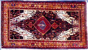 PERSIAN HAMADAN CARPET with large concentric diamond shaped crimson on midnight blue on a white