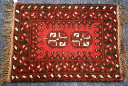 SMALL AFGHAN RUG, crimson with white detail, 1ft 10in x 1ft 3in ((60 x 40cm) and 4 OTHER SMALL RUGS,