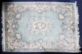 WASHED CHINESE EMBOSSED CARPET OF AUBUSSON DESIGN with white and floral oval centre medallion and