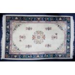 WASHED CHINESE EMBOSSED ALL-WOOL CARPET with circular centre medallion, on an ivory field with a