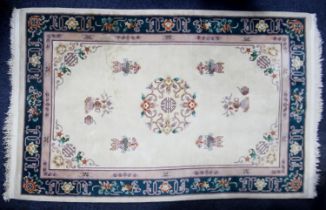 WASHED CHINESE EMBOSSED ALL-WOOL CARPET with circular centre medallion, on an ivory field with a