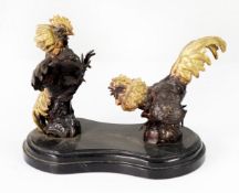 20th CENTURY BRONZED METAL FIGURES OF TWO FIGHTING COCKS, with gilt painted detail mounted on a