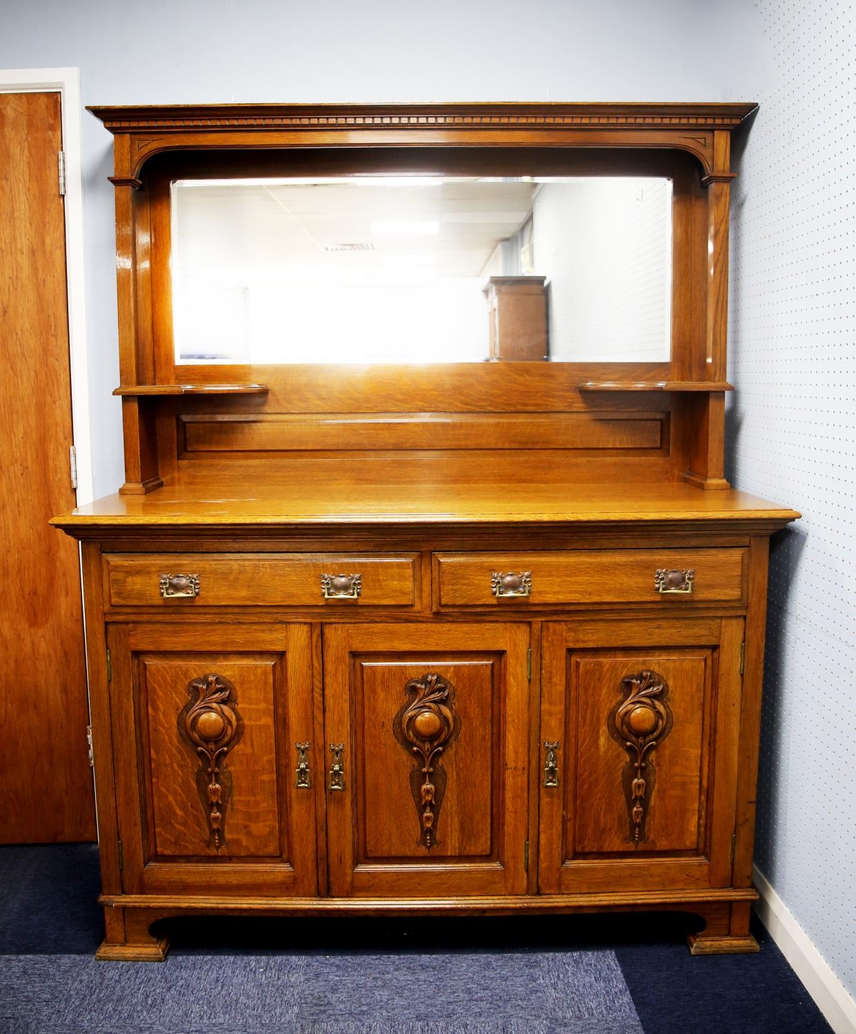 EARLY TWENTIETH CENTURY ARTS AND CRAFTS LIGHT OAK MIRROR BACK SIDEBOARD, the canopied back with