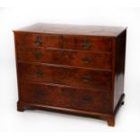 ANTIQUE FIGURED WALNUT AND FEATHER BANDED CHEST OF DRAWERS, the quarter cut oblong top with oval