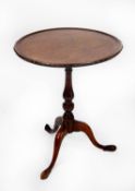 GEORGIAN LINE INLAID MAHOGANY TILT TOP OCCASIONAL TABLE, the circular dished top with carved cyma