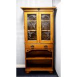 EARLY TWENTIETH CENTURY ARTS AND CRAFTS LIGHT OAK AND LEAD GLAZED BOOKCASE, the flat cornice above a