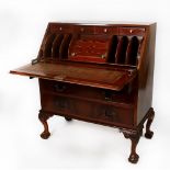 CHIPPENDALE STYLE FLAME FIGURED MAHOGANY BUREAU with sloping fall-front suppirted by self-