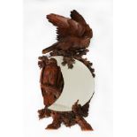 BLACK FOREST STYLE CARVED FRUITWOOD CRESCENT MIRROR, with bas relief carved eagles on naturalistic
