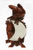 BLACK FOREST STYLE CARVED FRUITWOOD CRESCENT MIRROR, with bas relief carved eagles on naturalistic