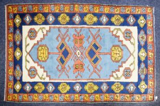 KARS, TURKISH WOOL RUG with geometric triple medallion pattern with pendants on a sky blue field