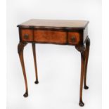 EARLY/ MID TWENTIETH CENTURY FIGURED WALNUT LADY’S SMALL SERPENTINE FRONTED WRITING TABLE, the