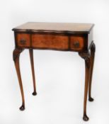 EARLY/ MID TWENTIETH CENTURY FIGURED WALNUT LADY’S SMALL SERPENTINE FRONTED WRITING TABLE, the