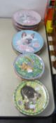 A SET OF TWELVE AYNSLEY CHINA COLLECTOR’S PLATES DECORATED WITH A NAMED CAT FOR EACH MONTH OF THE