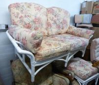 A WHITE ENAMELLED BAMBOO CONSERVATORY TWO SEATER SETTEE WITH OUT-SCROLLED ARMS AND SIX LOOSE BACK,