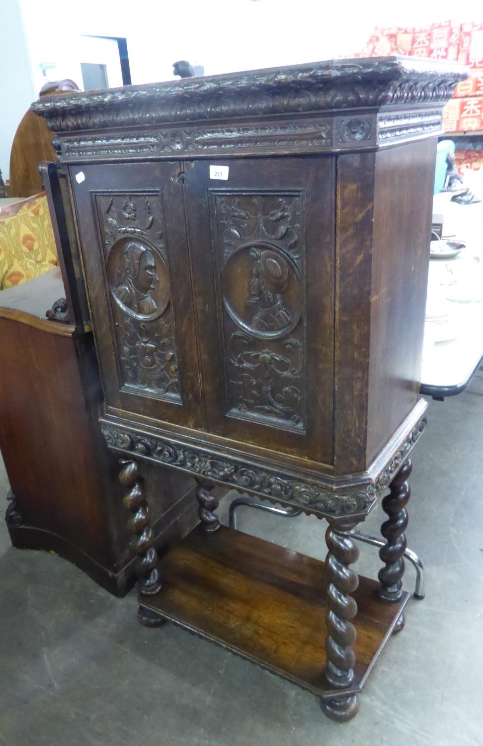 1930’S CABINET ON STAND, WITH EARLIER 18TH CENTURY CARVED PANEL DOORS