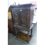 1930’S CABINET ON STAND, WITH EARLIER 18TH CENTURY CARVED PANEL DOORS