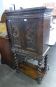 1930’S CABINET ON STAND, WITH EARLIER 18TH CENTURY CARVED PANEL DOORS