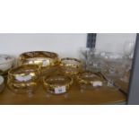 A GLASS FRUIT SET OF 6 BOWLS AND A LARGE FRUIT BOWL WITH BROAD GILT BORDERS WITH FOLIATE RESISTS, ON