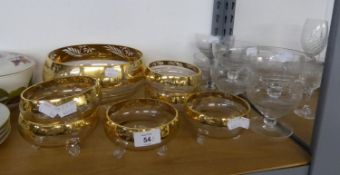 A GLASS FRUIT SET OF 6 BOWLS AND A LARGE FRUIT BOWL WITH BROAD GILT BORDERS WITH FOLIATE RESISTS, ON