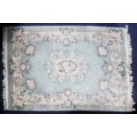 WASHED CHINESE EMBOSSED CARPET OF AUBUSSON DESIGN with white and floral oval centre medallion and