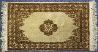 EASTERN RUG with light brown small centre floral medallion on a plain fawn field with shaped