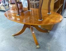 A YEW WOOD REGENCY STYLE OVAL LOW CENTRE TABLE, WITH EBONY STRING INLAY, CROSSBANDED BORDER, ON