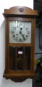 OAK WELLINGTON WALL CLOCK, WITH SILVERED ARABIC DIAL AND BEVELLED GLASS PANELS