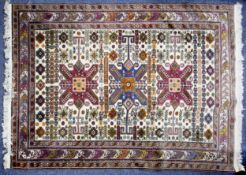 EASTERN SMALL CARPET OF KUBA, CAUCASIAN DESIGN, with large triple star pattern medallions on a white